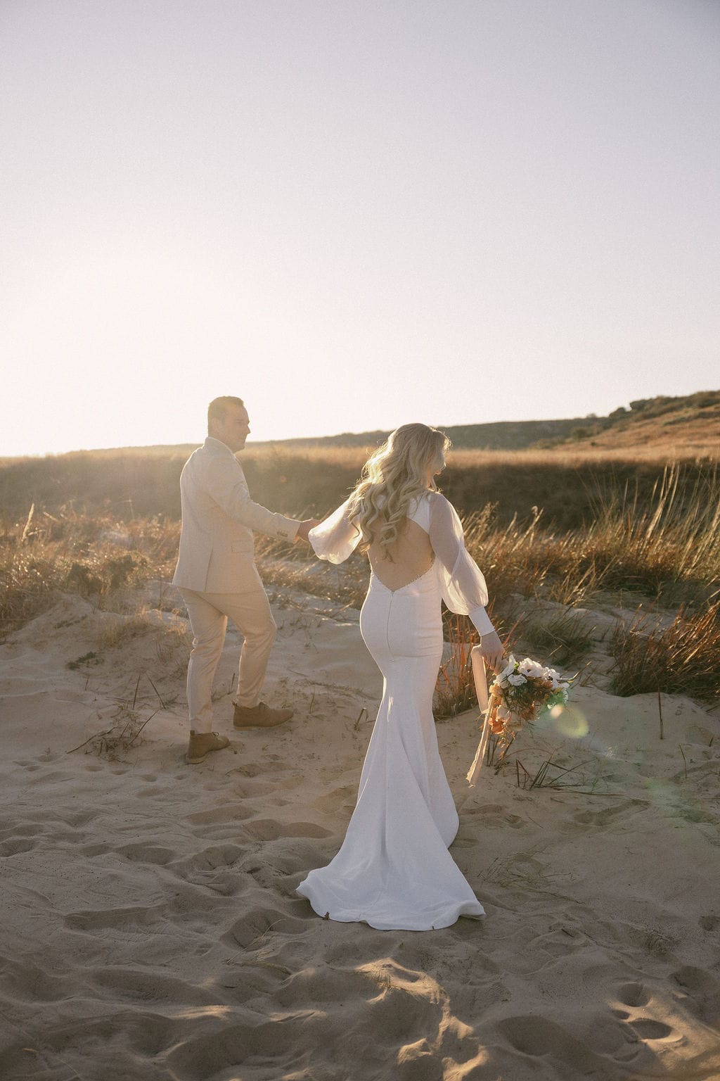Pre-loved Elary wedding dress with sheer tulle puff sleeves and deep V-neckline
