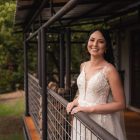 Pre-loved Rochell wedding gown featuring lace detailing and a flowing train