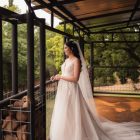 Pre-loved Rochell wedding gown featuring lace detailing and a flowing train