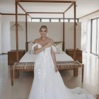 Bride wearing the Hannah romantic tulle A-line wedding dress with floral lace appliqués