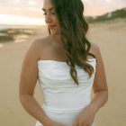 Lily satin strapless wedding dress with draped neckline and button-back detailing.