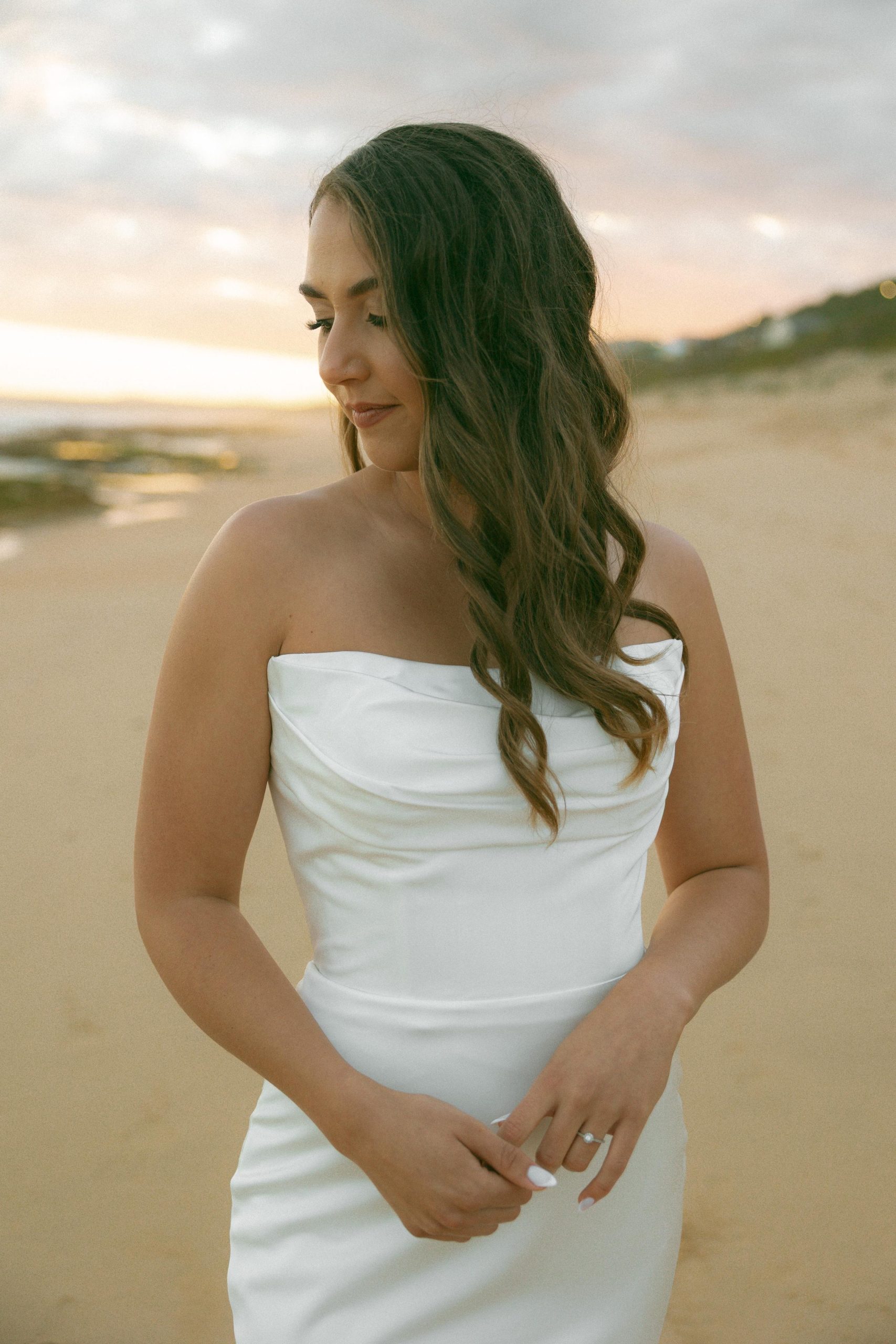 Lily satin strapless wedding dress with draped neckline and button-back detailing.