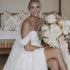 Bride wearing the Hannah romantic tulle A-line wedding dress with floral lace appliqués