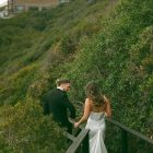Lily satin strapless wedding dress with draped neckline and button-back detailing.