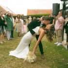 Lily satin strapless wedding dress with draped neckline and button-back detailing.