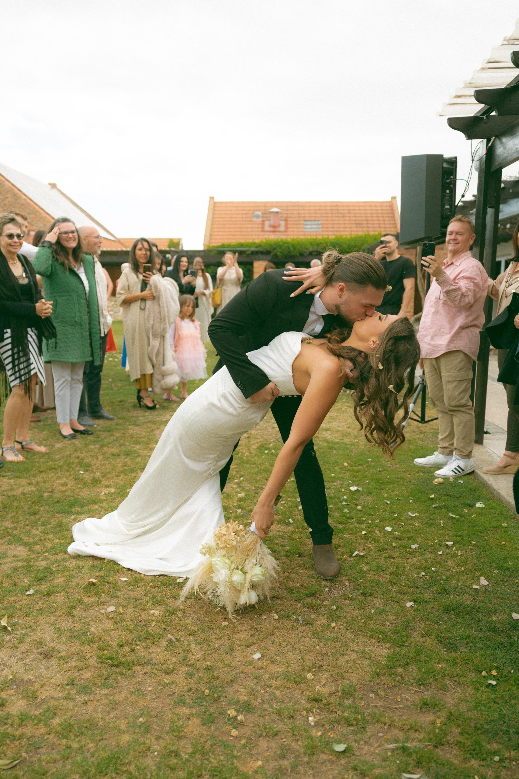 Lily satin strapless wedding dress with draped neckline and button-back detailing.