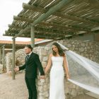 Lily satin strapless wedding dress with draped neckline and button-back detailing.