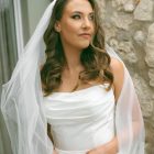 Lily satin strapless wedding dress with draped neckline and button-back detailing.