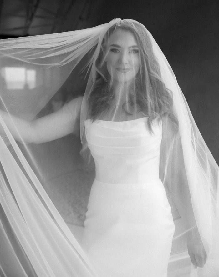 Lily satin strapless wedding dress with draped neckline and button-back detailing.