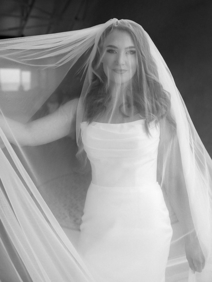 Lily satin strapless wedding dress with draped neckline and button-back detailing.