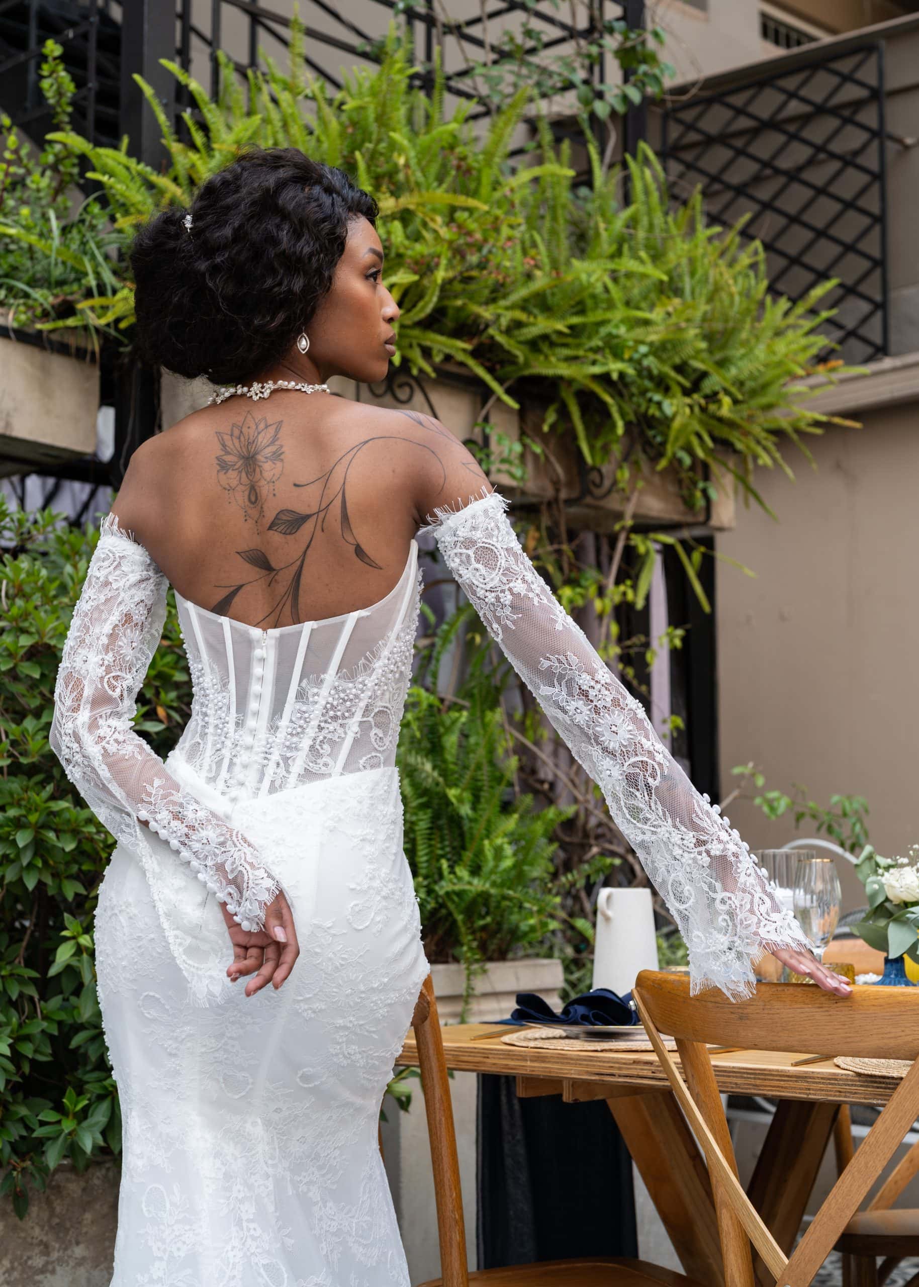 Back view of Ava Chantilly lace mermaid wedding gown with basque waist and lace train