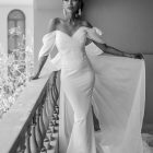 Full-length Anna crepe wedding gown featuring a draped sweetheart neckline, fitted silhouette and romantic organza sleeves.