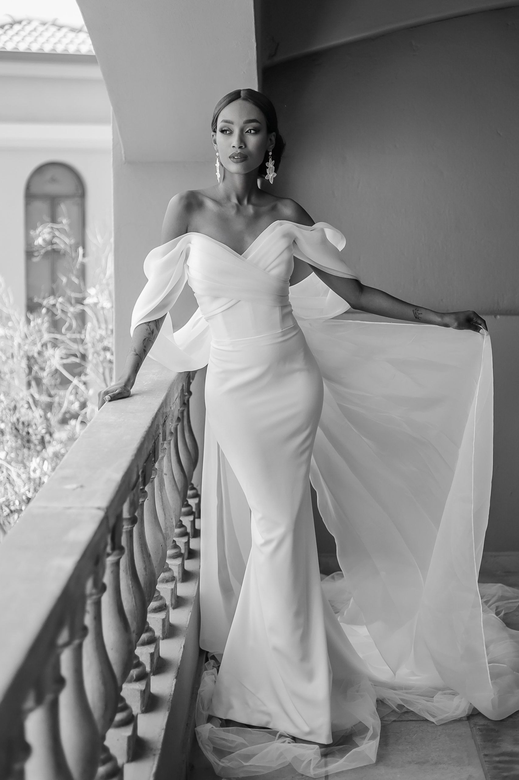 Full-length Anna crepe wedding gown featuring a draped sweetheart neckline, fitted silhouette and romantic organza sleeves.